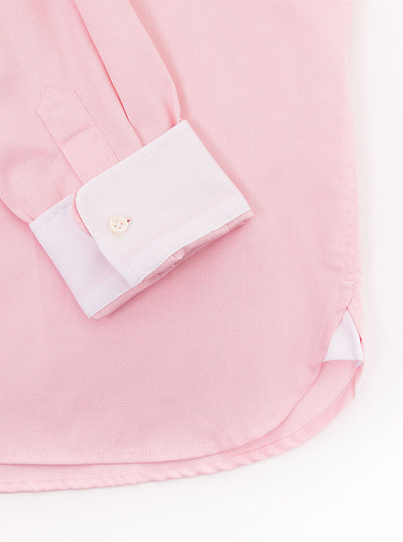 Flat lay of men's pale pink long sleeved shirt with a button down collar made with 100% cotton in a Thomas Mason fabric.